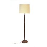 A 1960's turned teak and brass standard lamp with cream shade CONDITION REPORT: