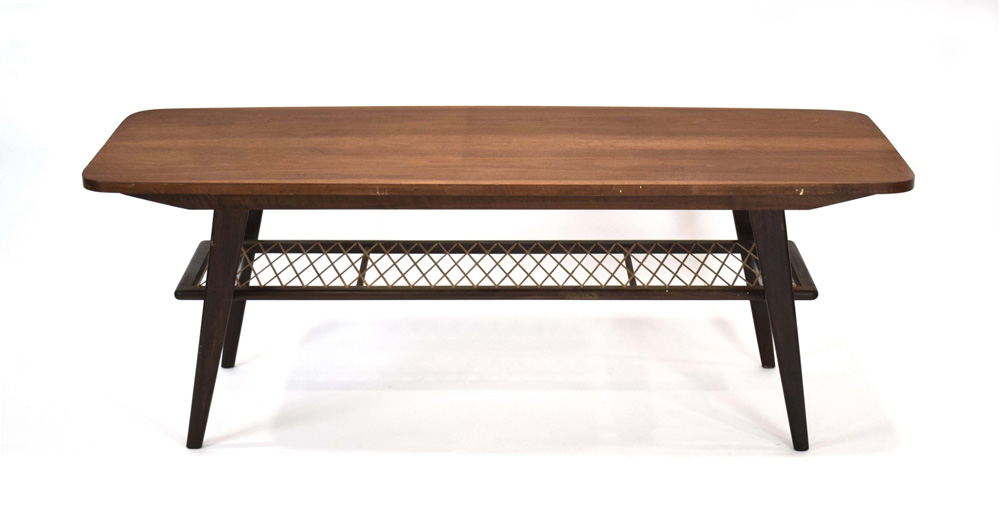 A 1960's Danish teak coffee table, the curved rectangular surface over a wicker criss-cross tier,