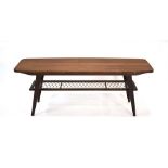 A 1960's Danish teak coffee table, the curved rectangular surface over a wicker criss-cross tier,