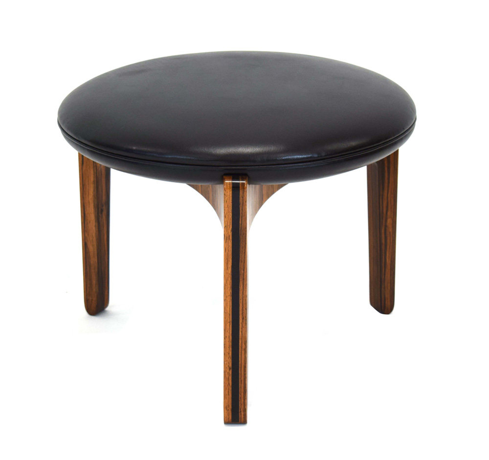 A 1960's rosewood and ebonised stool with black upholstery over a tri-form base *Sold subject to