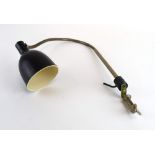 A Bauhaus-era black plastic desk-clamped lamp with a flexible shaft,