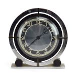 A Temco electric clock, the Art Deco case with black and chromed rings,