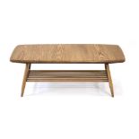 An Ercol occasional table, the elm surface over a second slatted tier, on tapering legs, l.