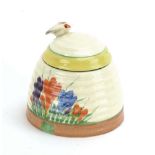 Clarice Cliff for Newport Pottery, a 'Crocus' pattern honey pot and cover surmounted by a bee, h.