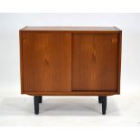 A Danish teak cabinet, the two sliding doors enclosing two shelved compartments, by Sejling Skave,