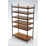 A 1960's British metal tubular shelving system with teak tiers, h.