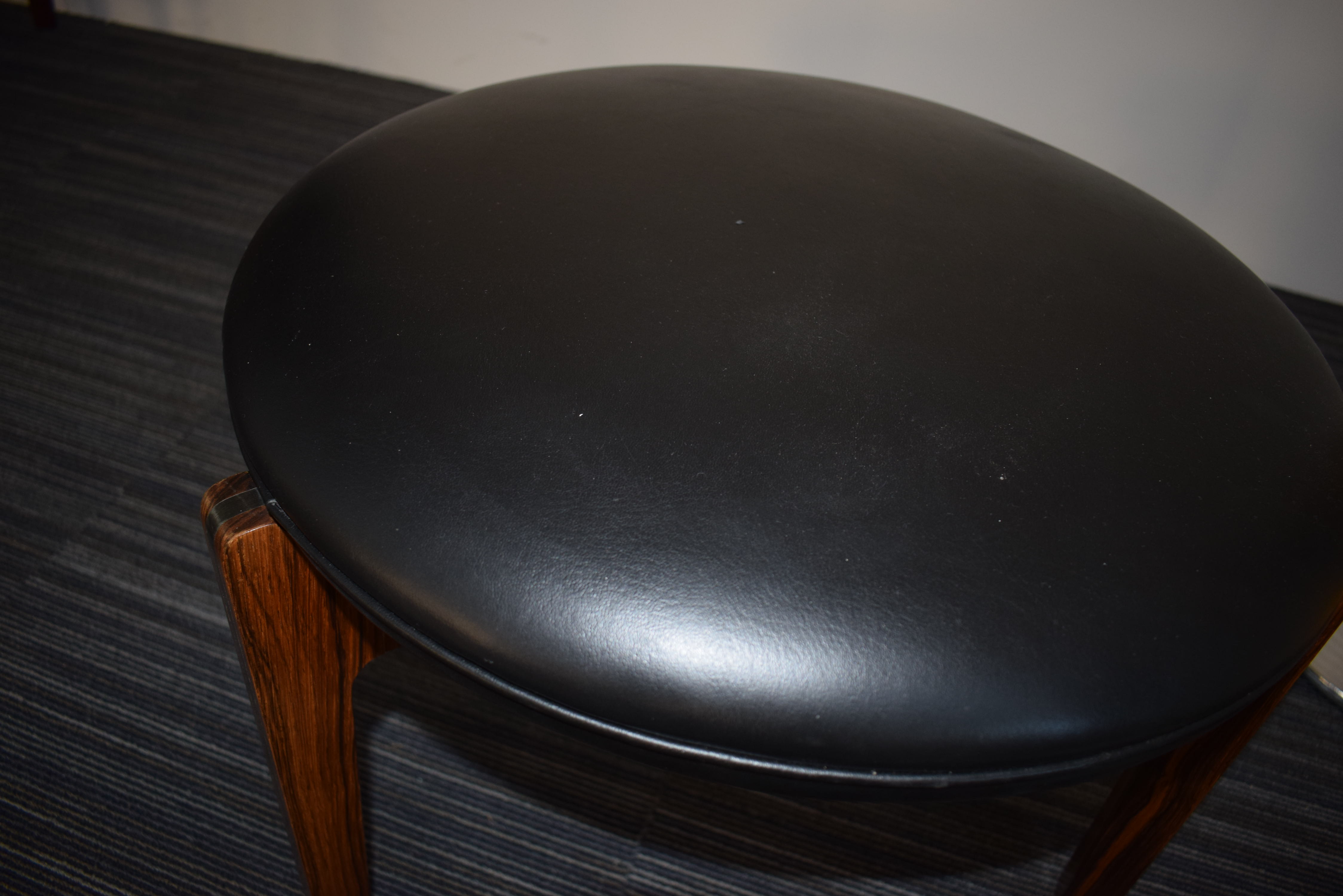 A 1960's rosewood and ebonised stool with black upholstery over a tri-form base *Sold subject to - Image 4 of 7