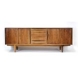 A 1960's Dyrlund rosewood sideboard with four sliding doors and four drawers, on tapering feet,
