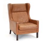 A Danish tan leather wingback lounge armchair in the manner of Borge Mogensen *Sold subject to our