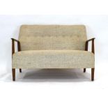 A 1960's Scandinavian two-seater cocktail sofa, the oatmeal button upholstery with a beech frame, l.