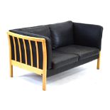 A Danish black two-seater sofa with an exposed beech frame by Stouby, l.