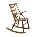 A 1960's beech spindle back rocking chair with organic-type arms designed by Illum Wikkelso