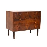 A Danish rosewood chest of four drawers with square handles and beech tapering legs, w.