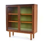 A 1960/70's Swedish teak cabinet, the two glazed doors enclosing adjustable shelves,