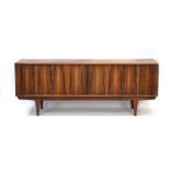 A 1960's rosewood Model 156 sideboard with a tambour door and tapering legs,