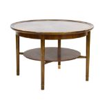 A 1950's Swedish walnut two-tier circular occasional table with beech tapering legs and brass caps,