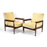 A pair of 1970's 'Manhatten' armchairs with teak frames, loose upholstery and tapering legs,