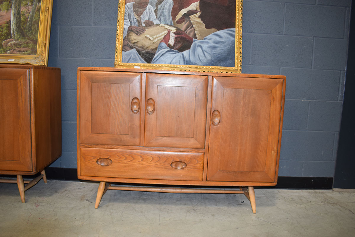 Ercol sideboard of 3 doors and single drawer Signs of wear, drawer stuck. Split on side of