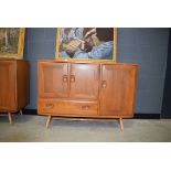 Ercol sideboard of 3 doors and single drawer Signs of wear, drawer stuck. Split on side of