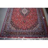 (11) An Iranian Pamchal carpet, red ground and blue border with Persian style foliate decoration