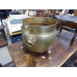 Brass cauldron with lions head ring handles on claw feet