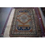 (16) Afghanistan hand woven carpet in shades of brown, cream and blue depicting geometric motifs,