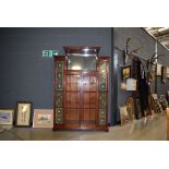 Late 19th/ Early 20th Century glazed mahogany cabinet in the arts and crafts manner, having pair