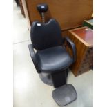Black faux leather barber's chair In need of attention