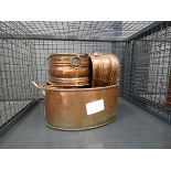 Cage containing copper planters and a preserve pan