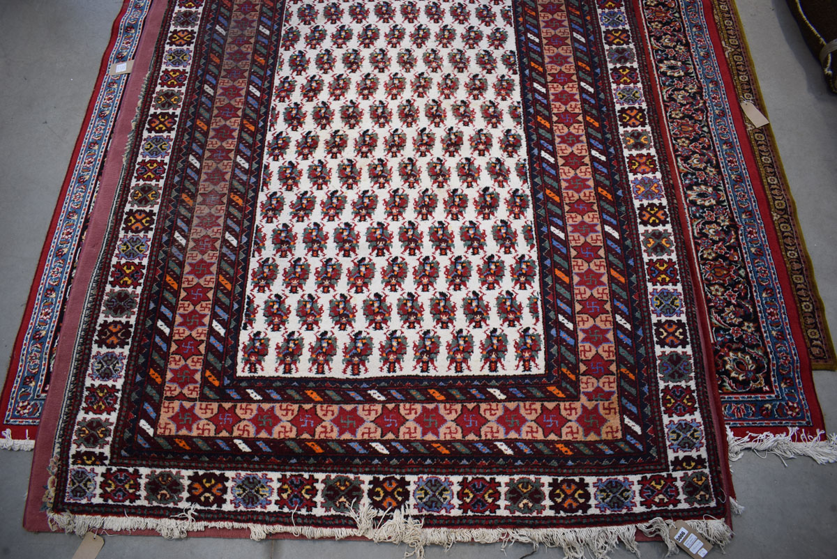 (14) Afghanistan wool carpet with white ground and red border and geometric motifs approx. 190 x