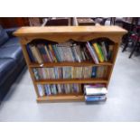 Pine 3 shelf bookcase, containing a quantity of novels by Dick Francis, Catherine Cookson and others