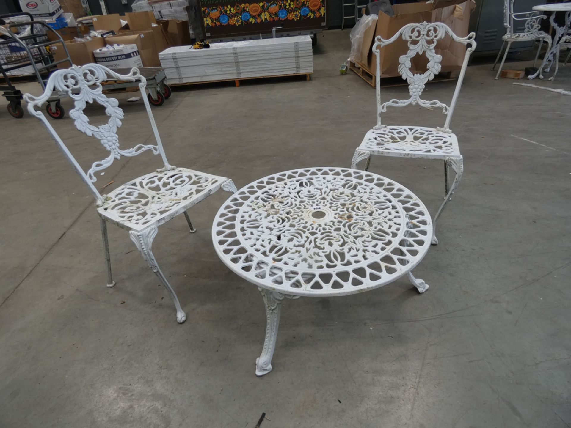 Low round metal garden table and 2 matching chairs