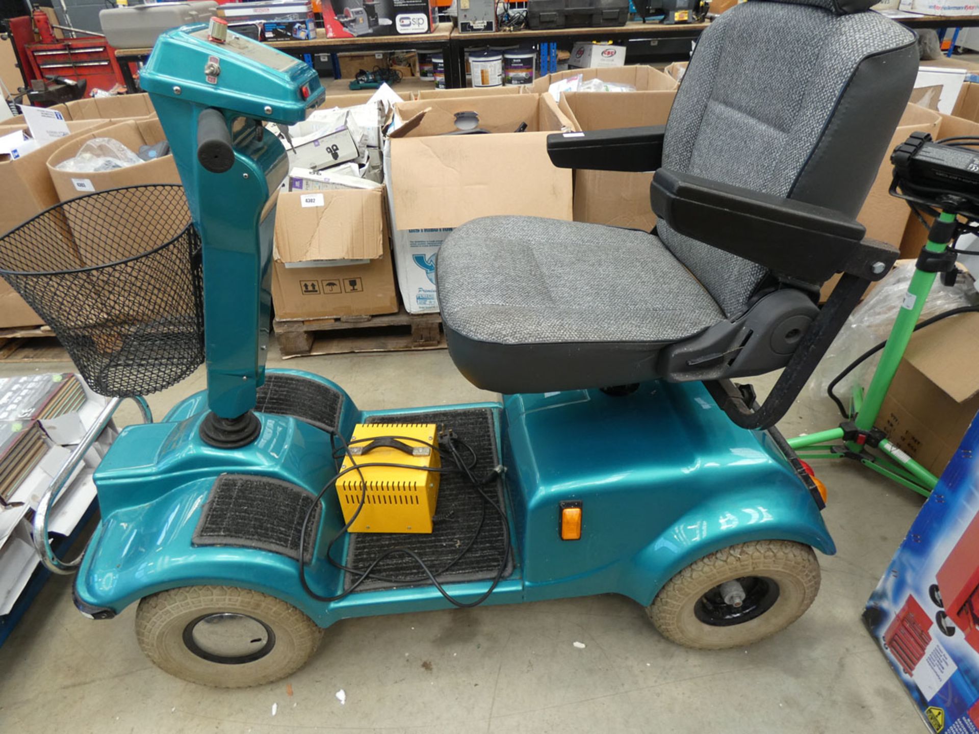 Turquoise mobility scooter with key and charger