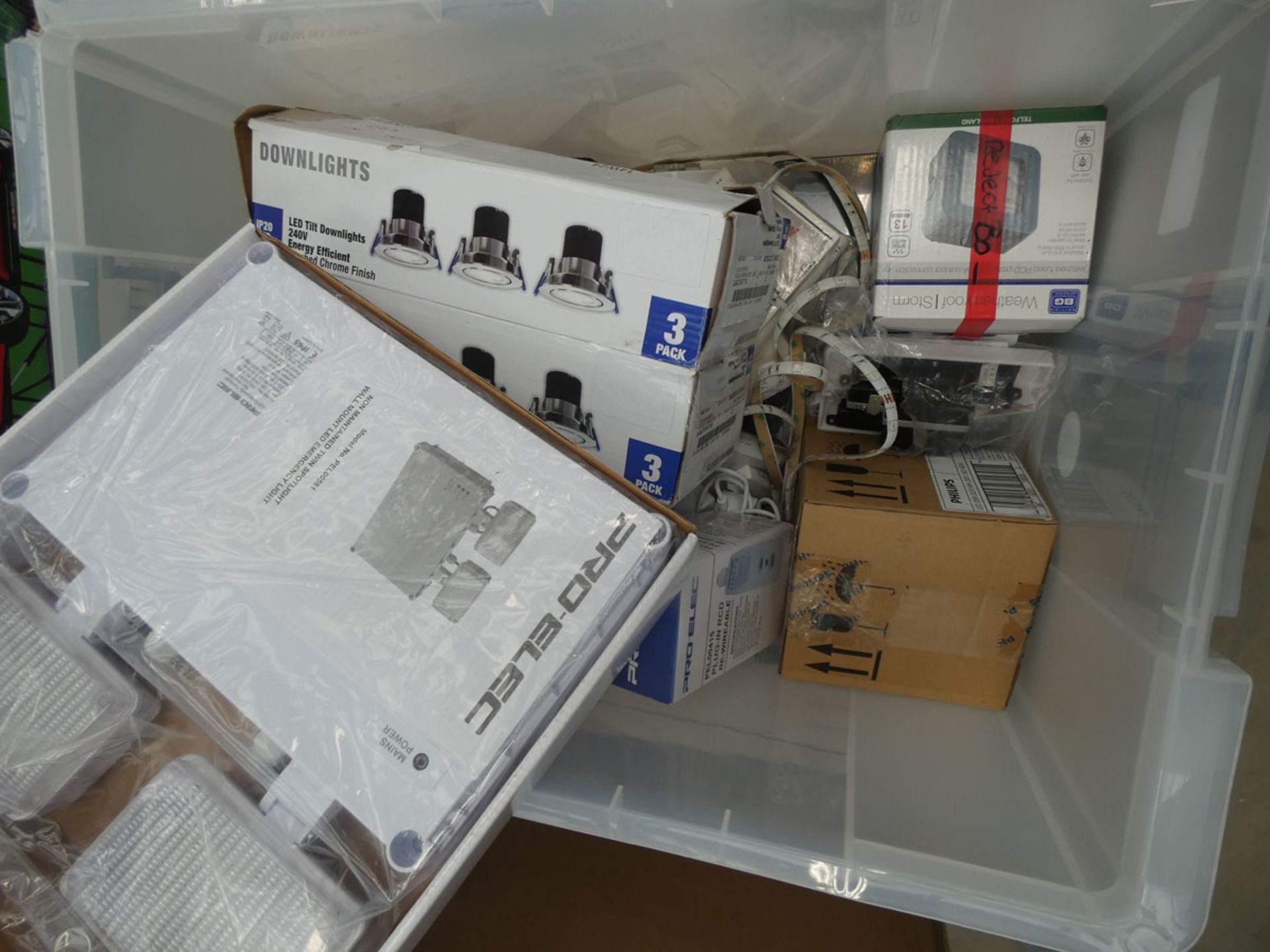 Box of downlights, weatherproof switches, plug-in RCDs, wall sockets, bulbs etc.