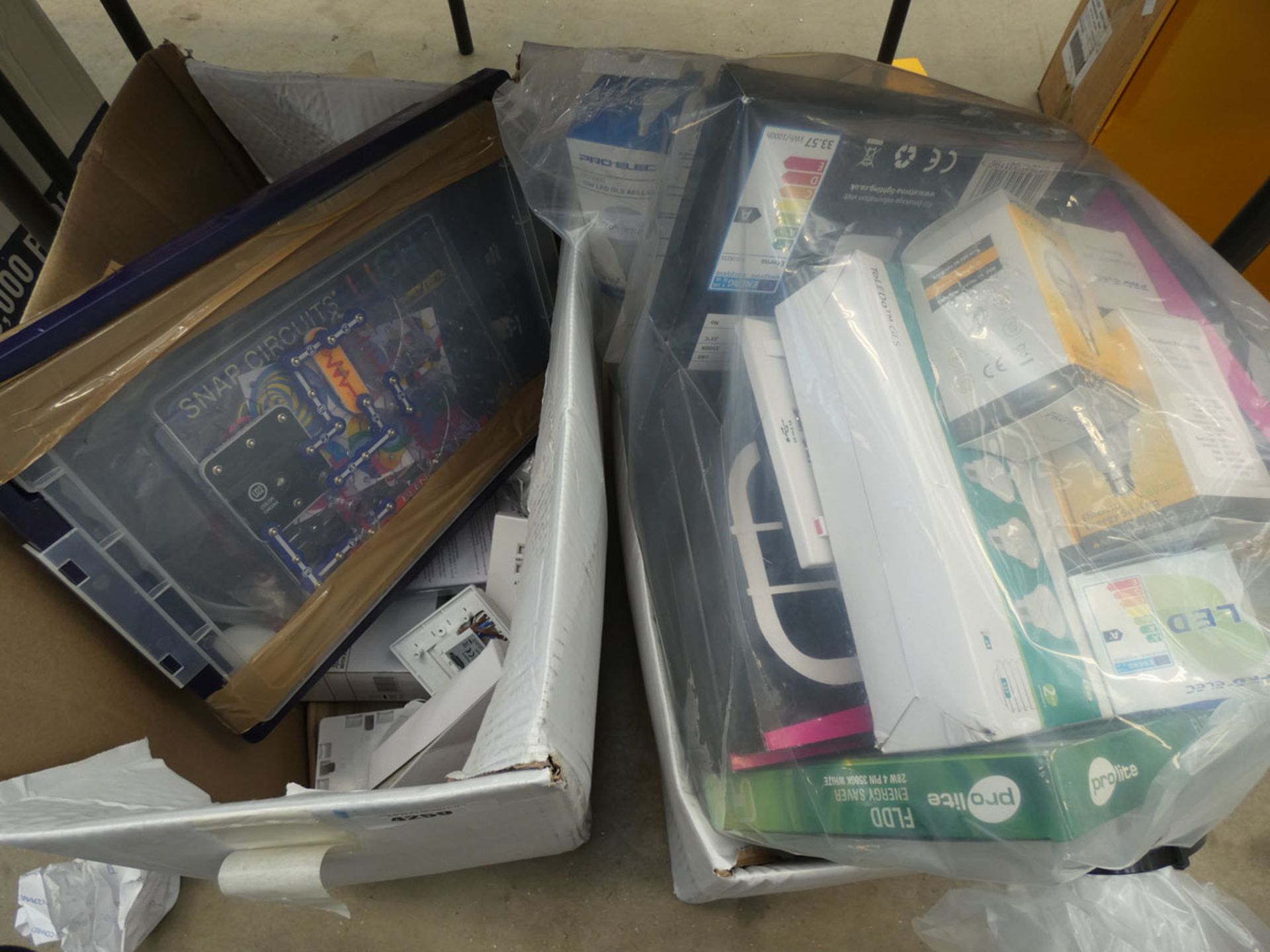 2 boxes containing bulbs, switches, sockets, snap circuits etc.