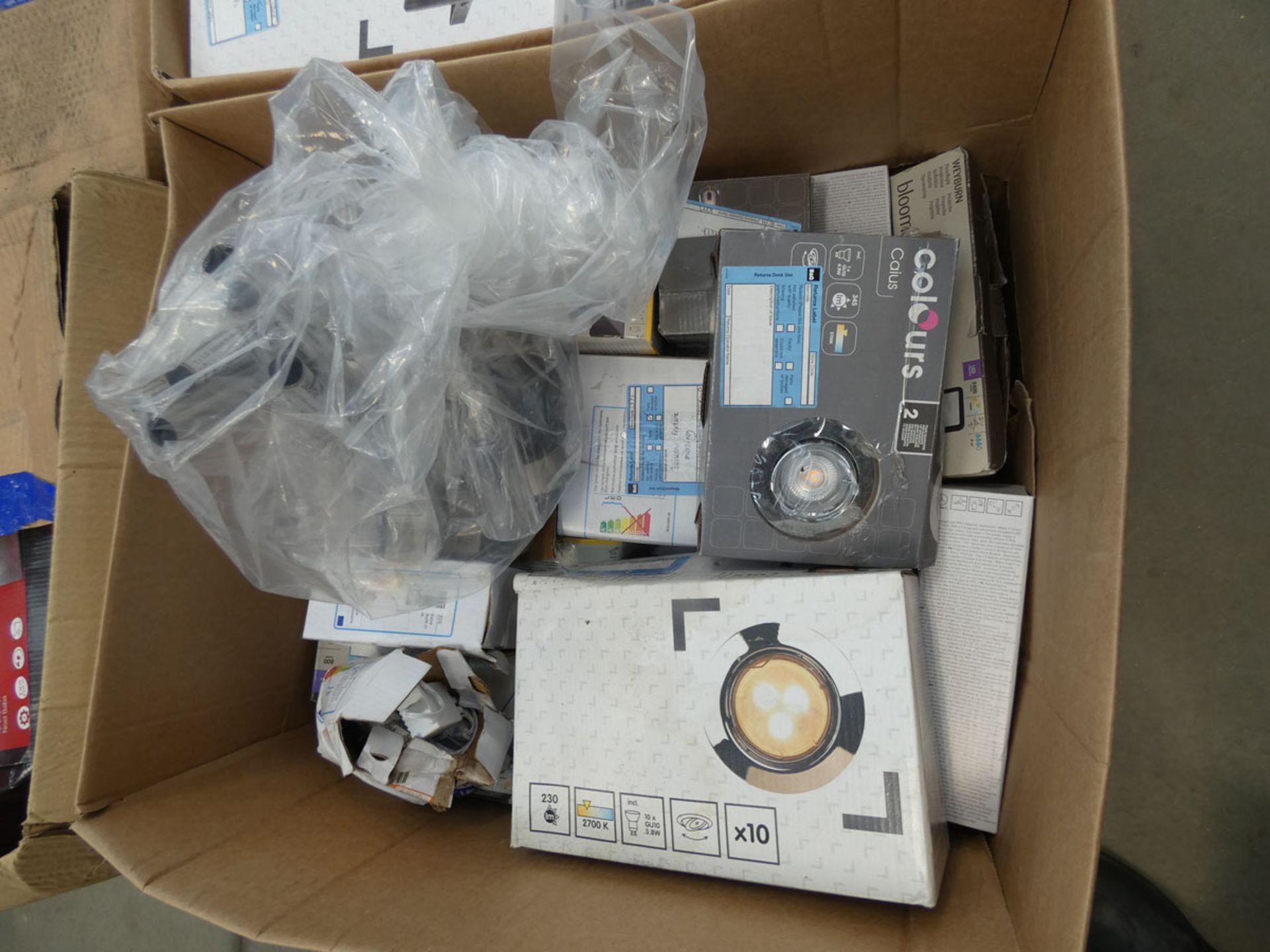 Box of downlights, security lights, and solar spike lights