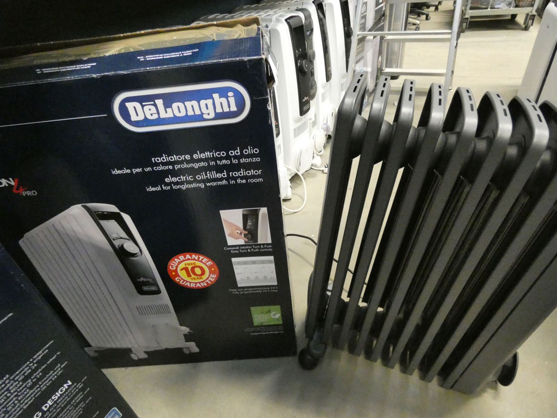 1 large boxed white Delonghi oil filled radiator, and 1 unboxed grey radiator