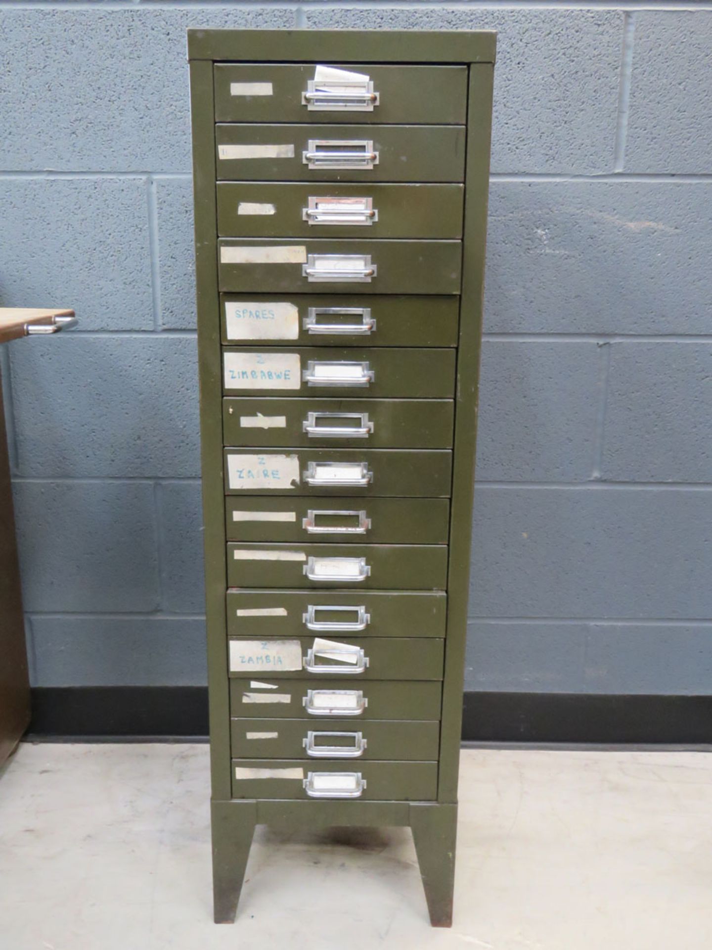 Narrow 15 drawer green metal filing cabinet In sound condition, but with paint loss and scratches