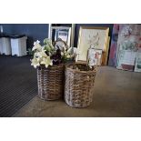 Pair of wicker baskets, containing a selection of artificial flowers