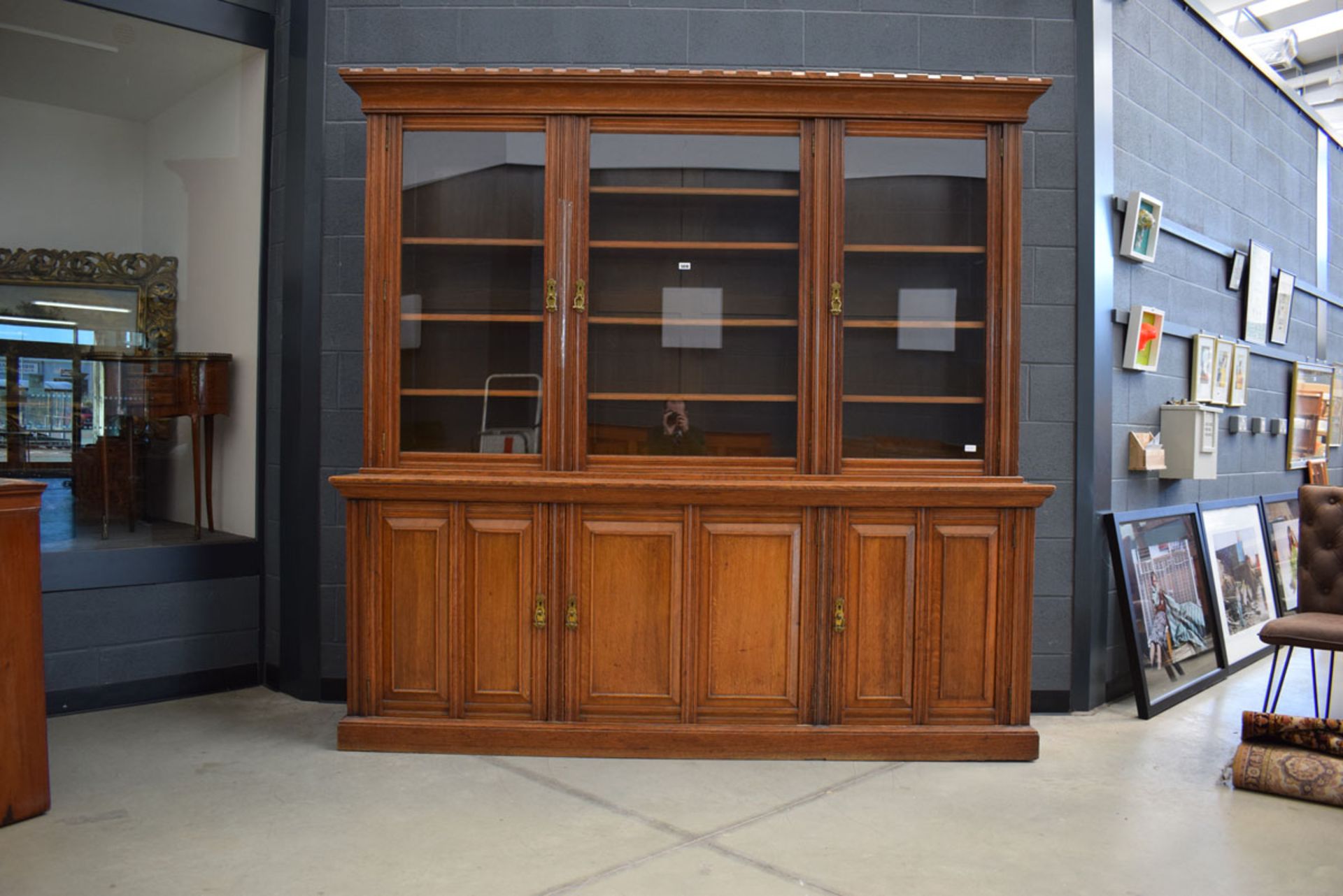 Glazed Victorian oak panelled three-door library bookcase with storage cupboards under and