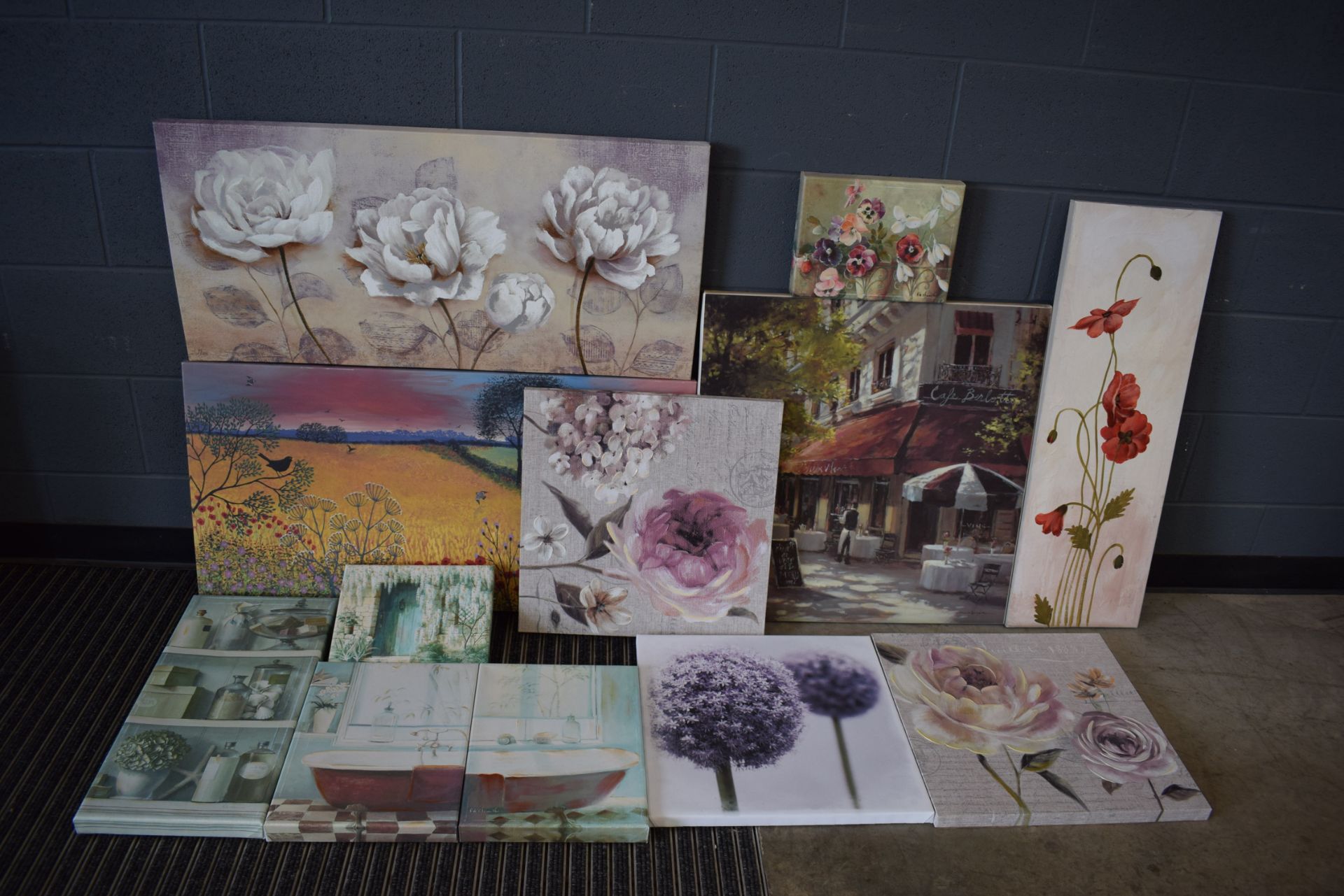 Stack of modern and printed canvases, mostly still life and floral arrangements