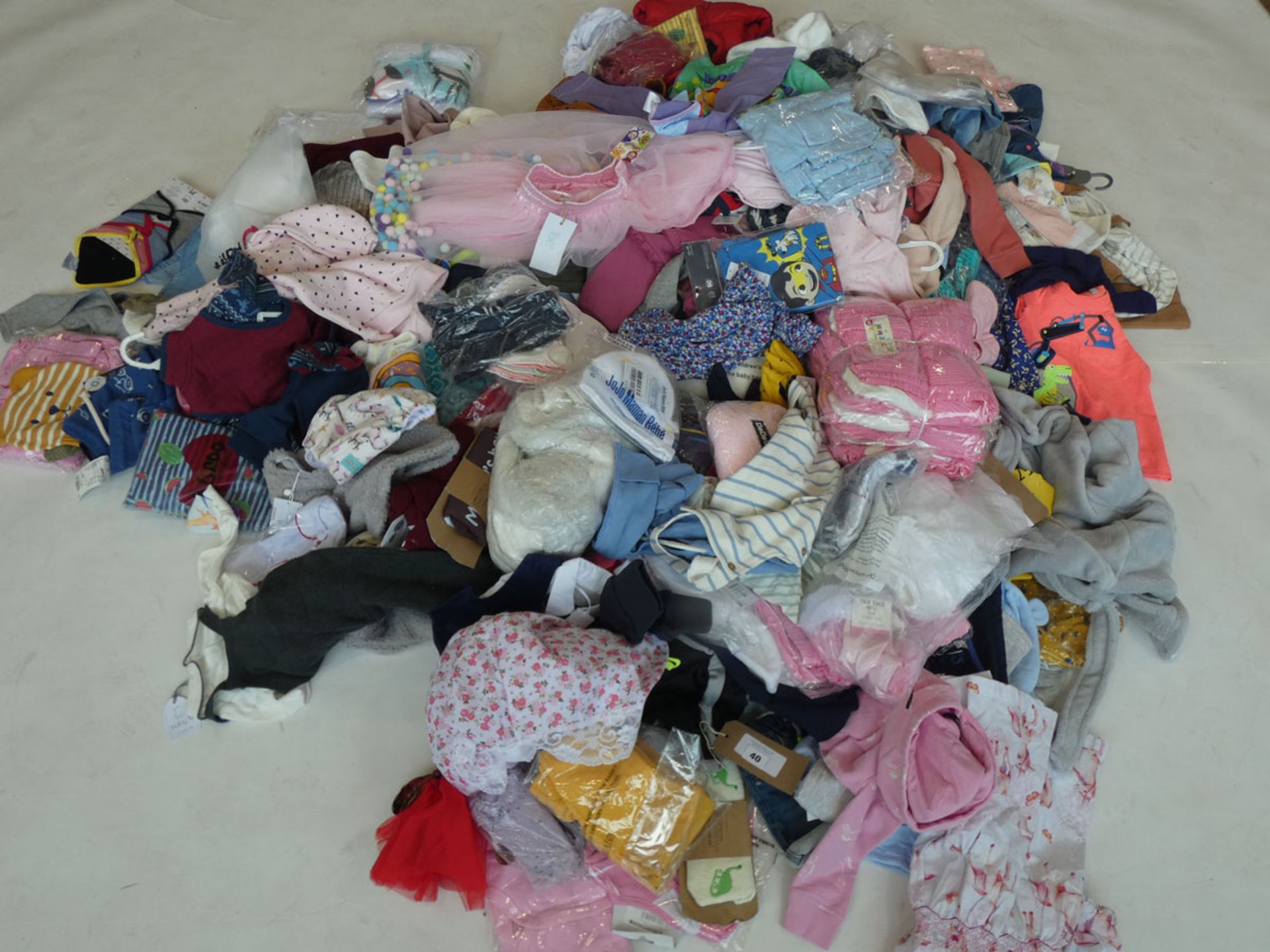 Half a stillage containing children's clothing and accessories ages 3 and under (approximately 235