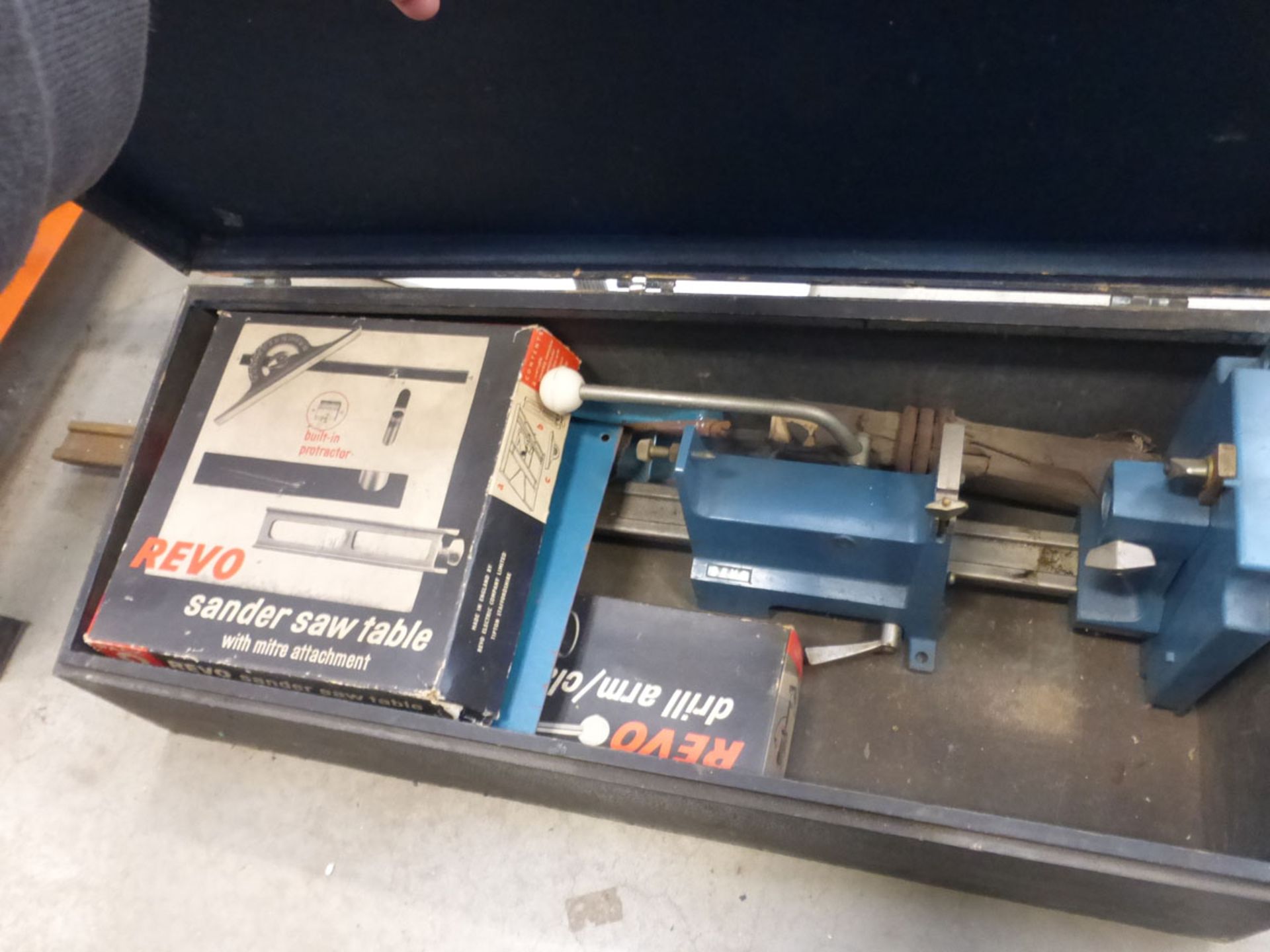 Metal box containing small lathe attachment, sander saw table with drill arm