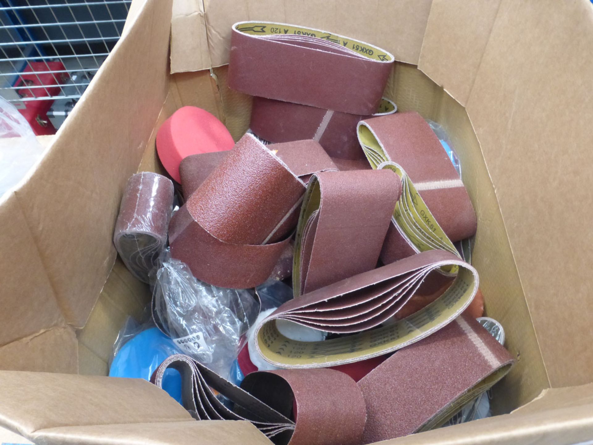 Large cardboard box of sanding belts and pads