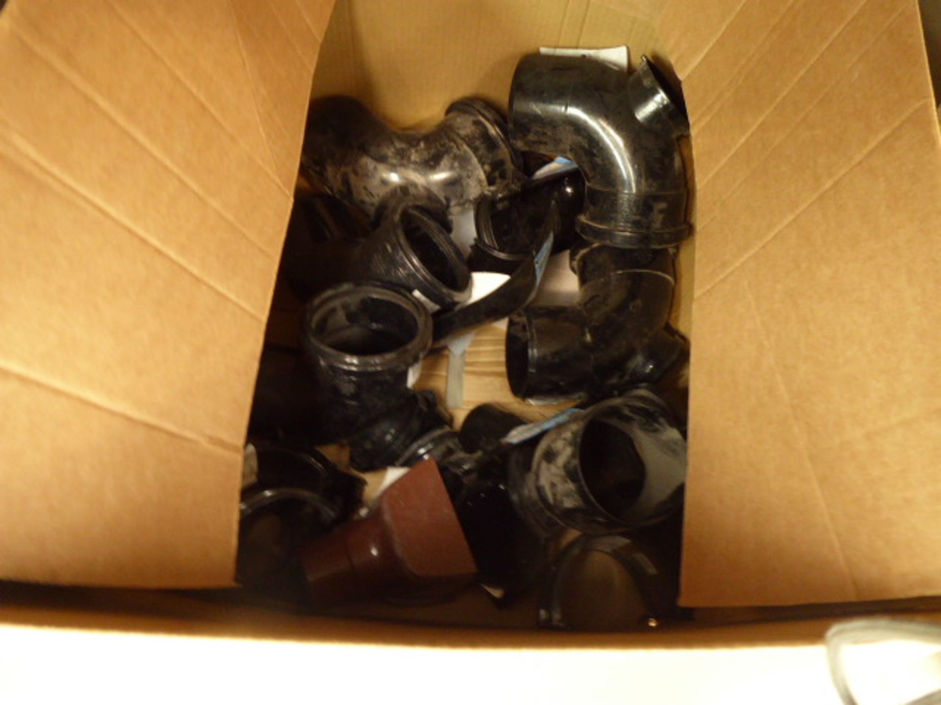 Small cardboard box of drain pipe and waste pipe fittings