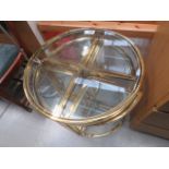 Brass finished and glazed circular table with 4 table nesting under W: 60cm, H: 56cm, Slight dent to