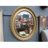 Oval bevelled mirror in gilt frame