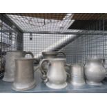 Cage containing pewter ale mugs