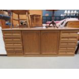 Large oak sideboard with central cupboard and drawers to side