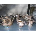 Cage containing silver plated teapots, jugs and sugar bowl